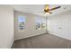 Well-lit bedroom with carpeted floors, three bright windows, and a large closet at 624 S Kennelman Cir, Wendell, NC 27591
