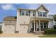Charming two-story home featuring a welcoming front porch, two-car garage, and classic curb appeal at 624 S Kennelman Cir, Wendell, NC 27591