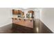 Bright, open kitchen with dark wood floors, stainless appliances, and large granite countertop island at 624 S Kennelman Cir, Wendell, NC 27591