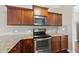 Stylish kitchen featuring stainless steel appliances, granite countertops, and custom cabinetry at 624 S Kennelman Cir, Wendell, NC 27591