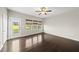 Sun-filled living room with hardwood floors, ceiling fan, and access to the backyard at 624 S Kennelman Cir, Wendell, NC 27591