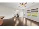 Open-concept living space with hardwood floors, stairs, and large windows for natural light at 624 S Kennelman Cir, Wendell, NC 27591