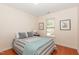 Comfortable bedroom with natural light, hardwood floors, and serene decor at 8721 Owl Roost Pl, Raleigh, NC 27617