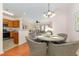 Cozy dining area with chandelier lighting and views into the living room and kitchen at 8721 Owl Roost Pl, Raleigh, NC 27617