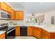 Bright kitchen with stainless steel appliances and generous counter space offering living room views at 8721 Owl Roost Pl, Raleigh, NC 27617