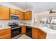 Well-maintained kitchen with stainless steel appliances and ample counter space overlooking the living area at 8721 Owl Roost Pl, Raleigh, NC 27617