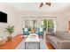 Cozy living room with hardwood floors, comfortable seating, a modern coffee table, and natural light from sliding doors at 8721 Owl Roost Pl, Raleigh, NC 27617