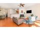 Bright living area with hardwood floors, fireplace, comfortable seating, and view into the open kitchen at 8721 Owl Roost Pl, Raleigh, NC 27617