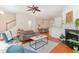 Open-concept living area with fireplace, hardwood floors, comfortable seating, and view into the dining space at 8721 Owl Roost Pl, Raleigh, NC 27617