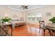 Serene main bedroom with tray ceiling, large windows, and hardwood flooring at 8721 Owl Roost Pl, Raleigh, NC 27617