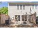 Inviting outdoor patio with a fire pit, seating, and views of the landscaped backyard at 8721 Owl Roost Pl, Raleigh, NC 27617