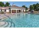 Resort-style community pool featuring crystal-clear water, lounge chairs, and a covered pavilion at 8721 Owl Roost Pl, Raleigh, NC 27617