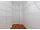Organized walk-in closet with multiple shelving units for optimal storage at 8721 Owl Roost Pl, Raleigh, NC 27617