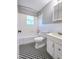 Bathroom with white tile walls, black and white checkerboard floors, and a white vanity at 919 E Main St, Haw River, NC 27258