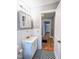 Bathroom with classic black and white checkerboard tile, white vanity, and gray walls at 919 E Main St, Haw River, NC 27258