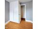 Bedroom contains wood look flooring, built in cupboards, and an open closet at 919 E Main St, Haw River, NC 27258