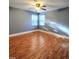 A spacious bedroom with natural light streaming through the windows and wood look floors at 919 E Main St, Haw River, NC 27258