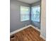 A bedroom features two windows with horizontal blinds and light grey colored walls at 919 E Main St, Haw River, NC 27258