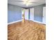 Spacious bedroom with laminate floors, gray walls, and a neutral color palette at 919 E Main St, Haw River, NC 27258