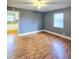 Bedroom featuring vinyl wood look floors, gray walls, white trim, and ceiling fan at 919 E Main St, Haw River, NC 27258