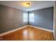 Empty bedroom with vinyl floors, gray walls, and white trim at 919 E Main St, Haw River, NC 27258