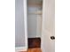 Close up of a closet with a single shelf, hanger rod, and dark hardwood floor at 919 E Main St, Haw River, NC 27258
