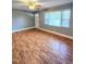 Bright living room featuring wood floors, fresh paint, and lots of natural light at 919 E Main St, Haw River, NC 27258