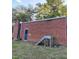 A brick outbuilding sits in the yard with wood stairs and a chimney at 919 E Main St, Haw River, NC 27258