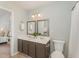 Bathroom featuring a double vanity, toilet, shower with curtain and neutral color palette at 9904 Erinsbrook Dr, Raleigh, NC 27617