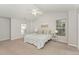 Bright main bedroom featuring a ceiling fan and two windows with ample natural light at 9904 Erinsbrook Dr, Raleigh, NC 27617