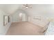 Bright bedroom with neutral walls, ceiling fan, and doorway to hallway at 9904 Erinsbrook Dr, Raleigh, NC 27617