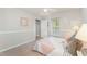 Bright bedroom with carpeted floor, window, and comfortable furnishings at 9904 Erinsbrook Dr, Raleigh, NC 27617