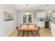 Dining area features a wooden table and chairs with a view of the backyard at 9904 Erinsbrook Dr, Raleigh, NC 27617