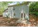 Exterior of home features a patio with chairs, siding, windows, and some mature trees at 9904 Erinsbrook Dr, Raleigh, NC 27617
