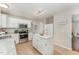 Bright kitchen features white cabinets, stainless steel appliances, and an island at 9904 Erinsbrook Dr, Raleigh, NC 27617