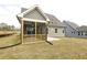 Exterior view showing backyard with a screened-in porch, gray siding, and grass at 0 Hwy 86, Cedar Grove, NC 27231