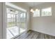 Bright dining area with screened porch access and modern light fixture at 0 Hwy 86, Cedar Grove, NC 27231