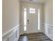 Bright entryway with white trim, wood-look flooring, and a white front door with sidelights at 0 Hwy 86, Cedar Grove, NC 27231