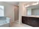 Bright bathroom featuring a double vanity, soaking tub, and glass-enclosed shower at 0 Sawmill, Cedar Grove, NC 27231