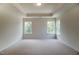Spacious bedroom with neutral carpet, tray ceiling, large windows with a view, and light walls at 0 Sawmill, Cedar Grove, NC 27231
