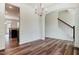 Open dining area with hardwood floors, classic white wainscoting, chandelier, and staircase views at 0 Sawmill, Cedar Grove, NC 27231