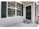 Inviting front entrance with stylish black door, stone accents, and well-maintained landscaping at 0 Sawmill, Cedar Grove, NC 27231