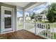 A charming porch shows houses nearby and white picket fence surrounding the yard at 0 Sawmill, Cedar Grove, NC 27231