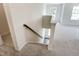 Staircase showcasing carpeted steps, a stained wood handrail, and natural light from the windows above at 0 Sawmill, Cedar Grove, NC 27231