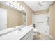 Bright bathroom with a single sink vanity, large mirror and a shower tub combo with safety bars at 1017 S Second Ave, Siler City, NC 27344