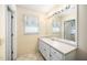 Well-lit bathroom area with a large vanity with a sink, cabinets, and a large mirror at 1017 S Second Ave, Siler City, NC 27344
