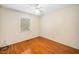 A simple bedroom with a light colored wall and hardwood floors and a window at 1017 S Second Ave, Siler City, NC 27344