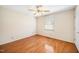Bedroom featuring hardwood floors, a ceiling fan and a window with natural light at 1017 S Second Ave, Siler City, NC 27344
