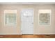Bright entryway showcasing hardwood floors, a classic white door, and double windows at 1017 S Second Ave, Siler City, NC 27344