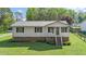 Charming single-story home with brick foundation, metal roof, and a well-manicured lawn at 1017 S Second Ave, Siler City, NC 27344